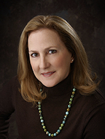 headshot of woman in brown shirt with necklace