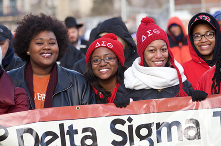 Four women smiling for camera during Martin Luther King Jr. march