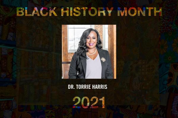 graphic reading Black History Month, Dr. Torrie Harris with image of woman smiling in light blue blouse and black blazer