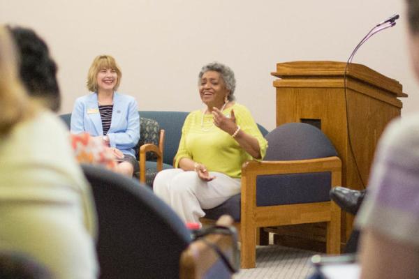 First Black woman to earn PhD from UK sitting in chair talking to group