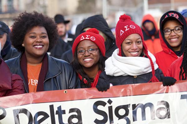 Four women smiling for camera during Martin Luther King Jr. march