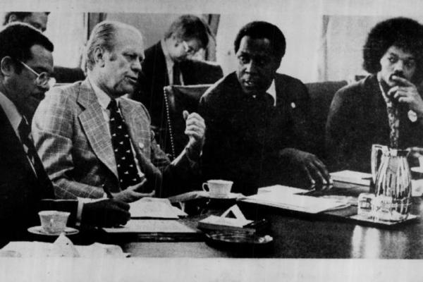Black and white photo of US President Gerald Ford officially recognizing Black History Month during meeting