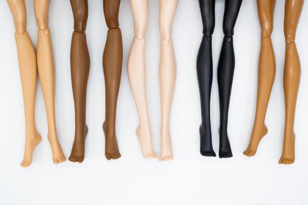 Photo of doll legs in different skin colors. 
