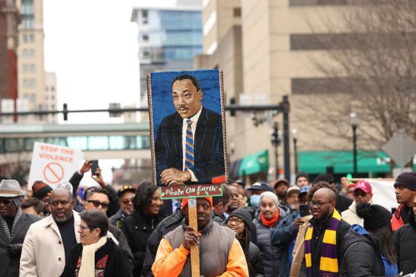 Group of people holding a picture of MLK at MLK parade 
