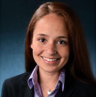 headshot of woman wearing suit jacket and lavender button up