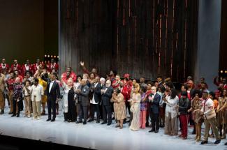 Cast of play standing for curtain call on stage at the Met Opera