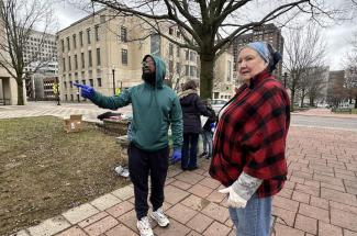 Jonathan Richardson leads a group of volunteers for Unity in the Community in downtown Lexington. The volunteers provide donated food and clothing to unhoused people in need.