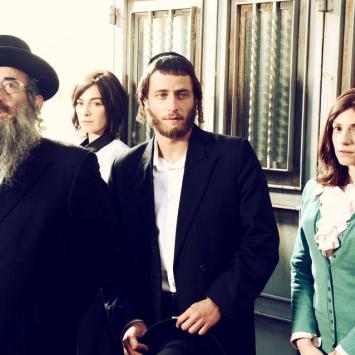 image of four Jewish individuals posing for camera